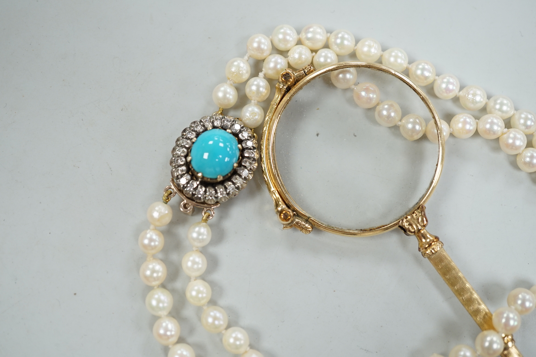 A twin strand cultured pearl choker necklace with yellow metal, blue enamel and diamond cluster set clasp, 36cm, together with a pair of yellow metal overlaid lorgnettes.